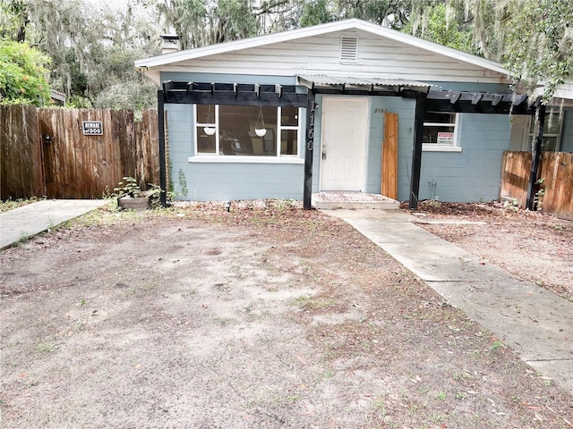 view of front of house with fence and a chimney