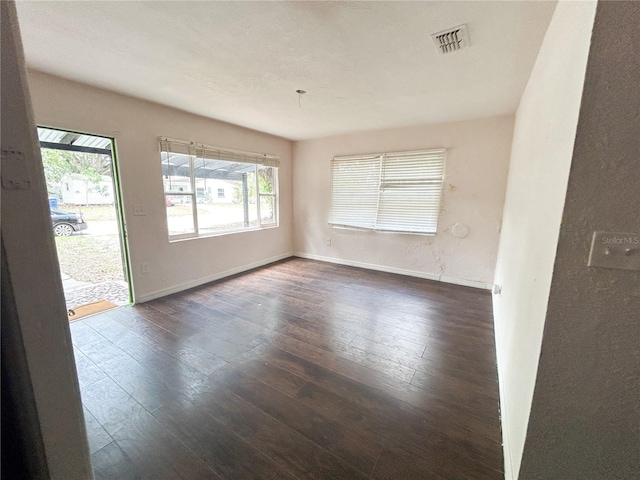 1160 Austin St, Bartow, FL 33830 - unfurnished room with plenty of natural light, dark wood finished floors, and baseboards