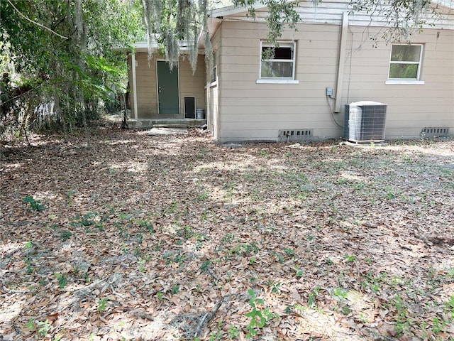 1160 Austin St, Bartow, FL 33830 - rear view of property featuring central air condition unit and crawl space