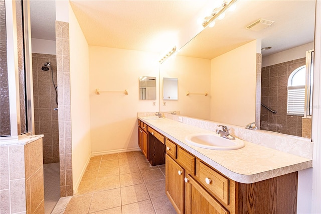 3798 N Chandler Dr, Hernando, FL 34442 - bathroom featuring double vanity, a walk in shower, tile patterned flooring, and baseboards