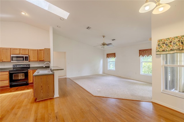 3798 N Chandler Dr, Hernando, FL 34442 - kitchen featuring black range with electric stovetop, a sink, stainless steel microwave, dark countertops, and open floor plan