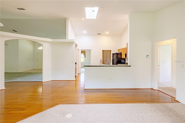 3798 N Chandler Dr, Hernando, FL 34442 - unfurnished living room with light wood-style flooring, arched walkways, recessed lighting, and baseboards