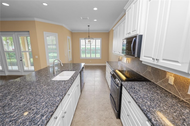 kitchen with a sink, range with two ovens, backsplash, light tile patterned floors, and ornamental molding