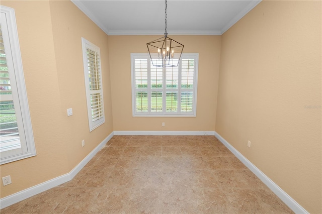 spare room with a chandelier, ornamental molding, and baseboards