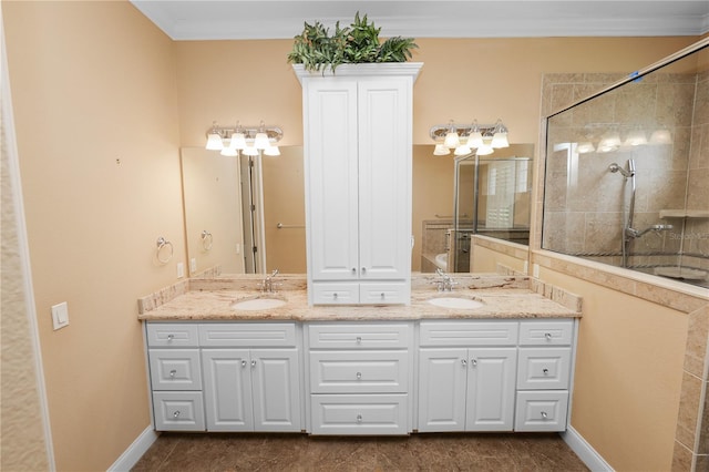 bathroom featuring double vanity, crown molding, tiled shower, and baseboards