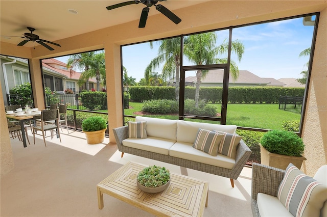 sunroom with a ceiling fan and an outdoor hangout area