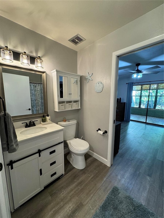 135 Wild Palm Dr, Bradenton, FL 34210 - bathroom with wood finished floors, vanity, ceiling fan, toilet, and baseboards