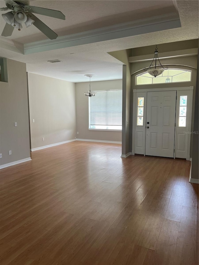 200 S Goodman Ave, Lake Alfred, FL 33850 - entrance foyer featuring healthy amount of natural light, wood finished floors, baseboards, crown molding, and a chandelier