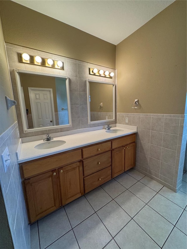 200 S Goodman Ave, Lake Alfred, FL 33850 - bathroom with tile walls, tile patterned flooring, double vanity, and wainscoting