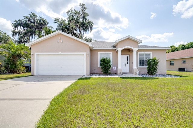 3281 Enclave Blvd, Mulberry, FL 33860 - view of front of house with stucco siding, a garage, a front lawn, driveway, and cooling unit