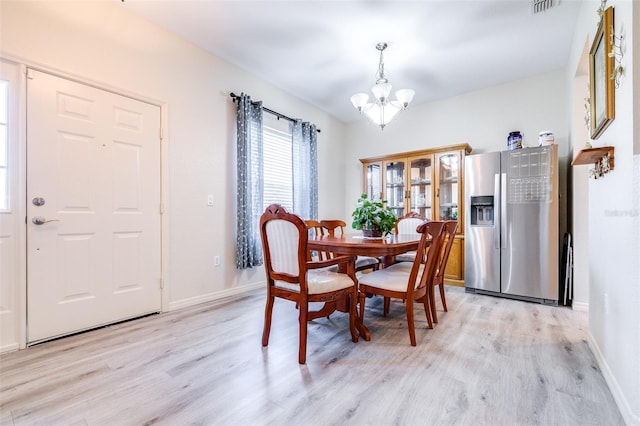 3281 Enclave Blvd, Mulberry, FL 33860 - dining area featuring a chandelier, light wood finished floors, and baseboards