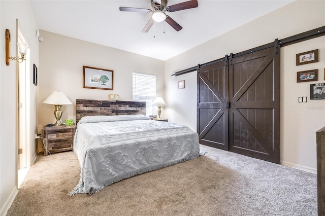 3281 Enclave Blvd, Mulberry, FL 33860 - carpeted bedroom with a barn door, baseboards, and a ceiling fan