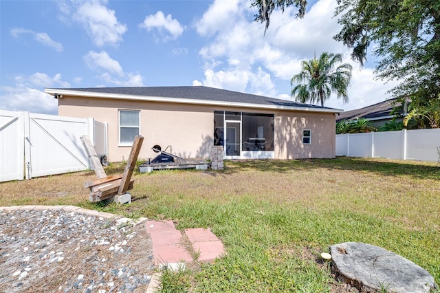3281 Enclave Blvd, Mulberry, FL 33860 - back of house with a gate, stucco siding, and a sunroom
