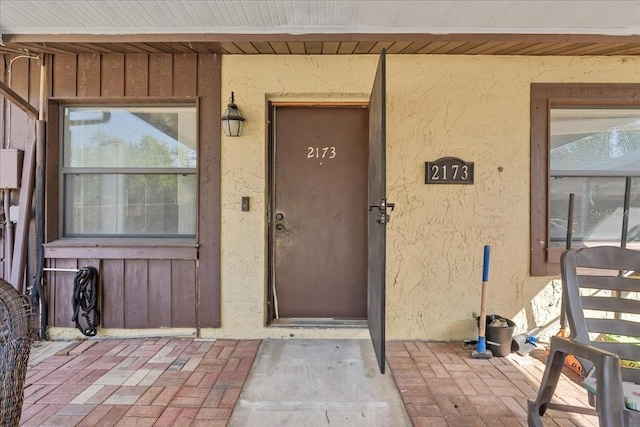 2173 Castle Pt, Winter Haven, FL 33880 - property entrance featuring stucco siding and board and batten siding