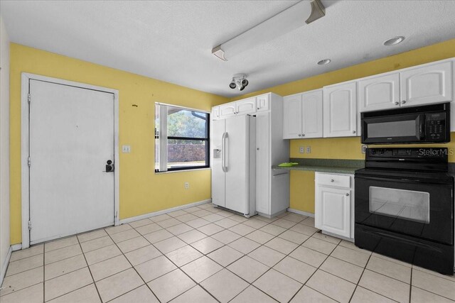 2173 Castle Pt, Winter Haven, FL 33880 - kitchen featuring black appliances, white cabinets, baseboards, a textured ceiling, and dark countertops