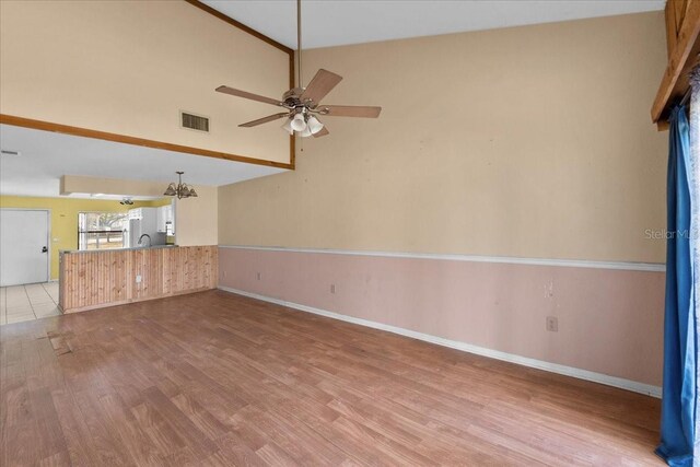 2173 Castle Pt, Winter Haven, FL 33880 - unfurnished room with light wood-style flooring, a ceiling fan, baseboards, a sink, and high vaulted ceiling