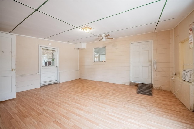 spare room with light wood finished floors, ceiling fan, and cooling unit