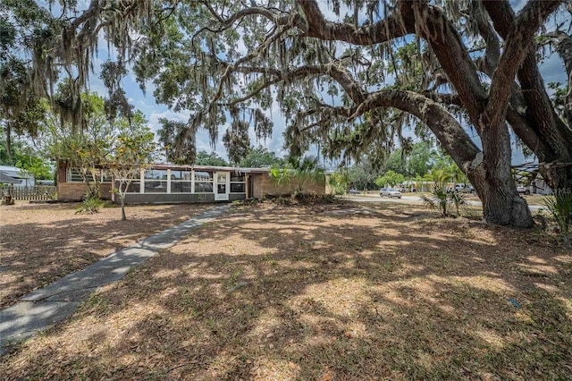 view of yard featuring a sunroom