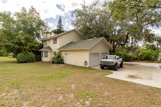 330 W Palmetto St, Lakeland, FL 33815 - view of home's exterior featuring a garage, driveway, a lawn, and a chimney