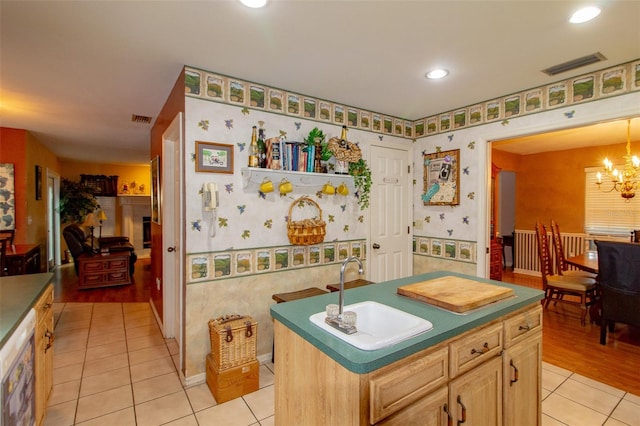330 W Palmetto St, Lakeland, FL 33815 - kitchen featuring a sink, light tile patterned floors, wallpapered walls, a chandelier, and dark countertops