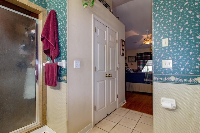 330 W Palmetto St, Lakeland, FL 33815 - ensuite bathroom with wallpapered walls, a stall shower, tile patterned flooring, and ceiling fan