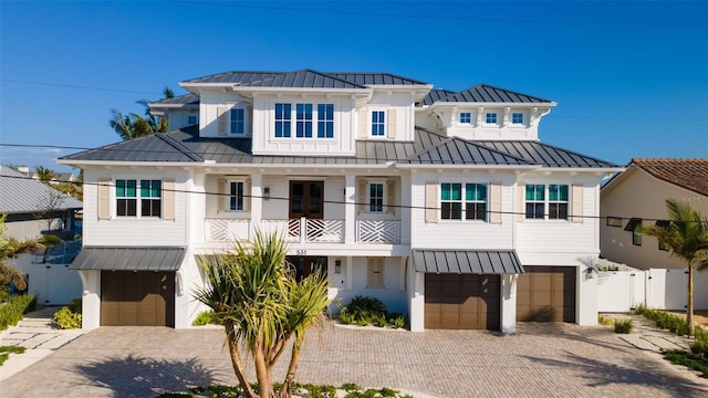 531 68th St, Holmes Beach, FL 34217 - view of front of property featuring a standing seam roof, a garage, metal roof, and decorative driveway