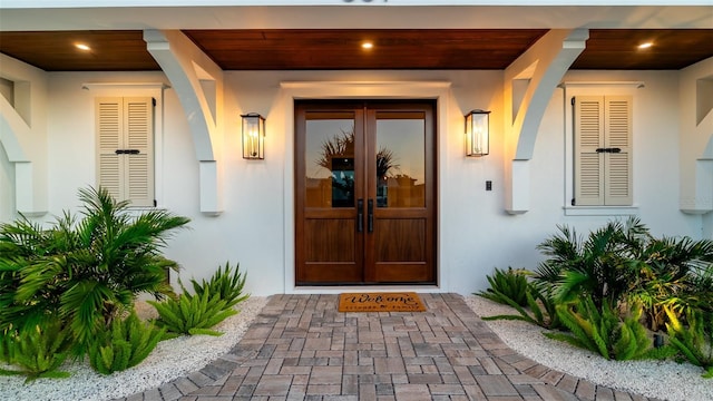 531 68th St, Holmes Beach, FL 34217 - entrance to property featuring stucco siding and french doors