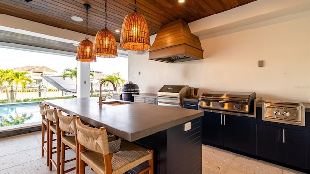 531 68th St, Holmes Beach, FL 34217 - kitchen featuring custom exhaust hood, wood ceiling, dark cabinetry, dark speckled floor, and a sink