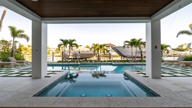 531 68th St, Holmes Beach, FL 34217 - view of pool featuring boat lift, a pool with connected hot tub, a dock, and a patio area