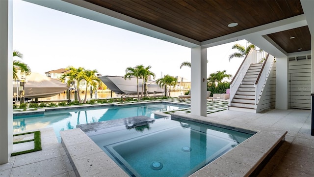 531 68th St, Holmes Beach, FL 34217 - view of swimming pool featuring stairway and a pool with connected hot tub