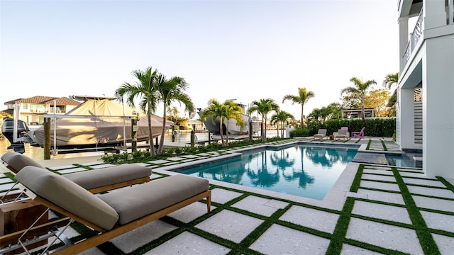531 68th St, Holmes Beach, FL 34217 - swimming pool with boat lift, a patio area, and a boat dock