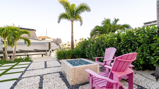531 68th St, Holmes Beach, FL 34217 - view of patio with boat lift, an outdoor fire pit, and a boat dock