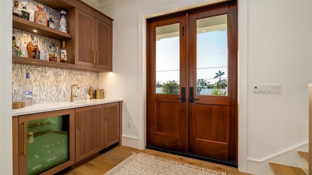 531 68th St, Holmes Beach, FL 34217 - indoor wet bar with wine cooler, light wood-style floors, and tasteful backsplash