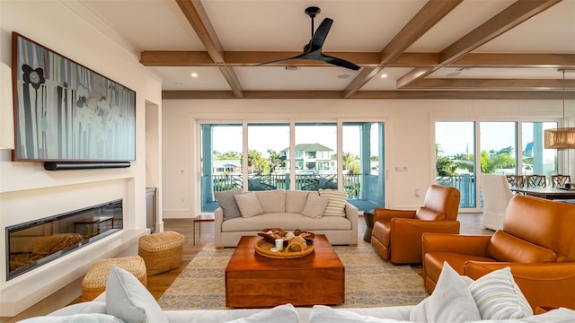 531 68th St, Holmes Beach, FL 34217 - living room with coffered ceiling, beamed ceiling, ceiling fan, a glass covered fireplace, and wood finished floors