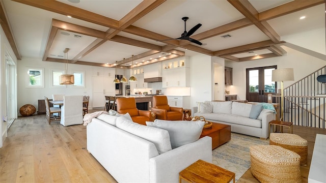 531 68th St, Holmes Beach, FL 34217 - living room featuring light wood-type flooring, a ceiling fan, coffered ceiling, beamed ceiling, and stairs