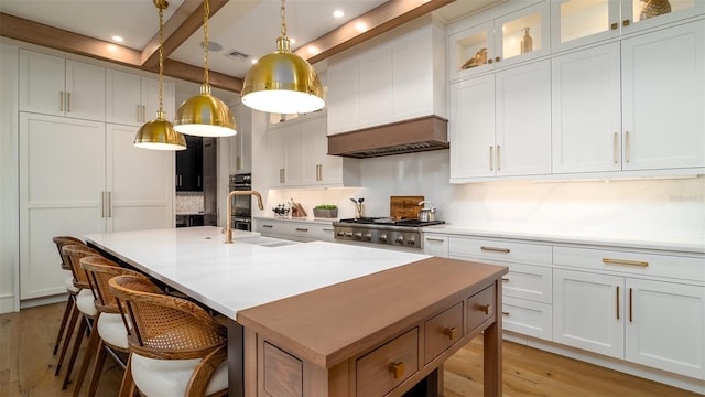 531 68th St, Holmes Beach, FL 34217 - kitchen featuring a center island with sink, light wood finished floors, a breakfast bar, light countertops, and recessed lighting