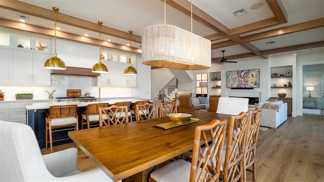 531 68th St, Holmes Beach, FL 34217 - dining room featuring beam ceiling, stairs, ceiling fan, wood finished floors, and coffered ceiling