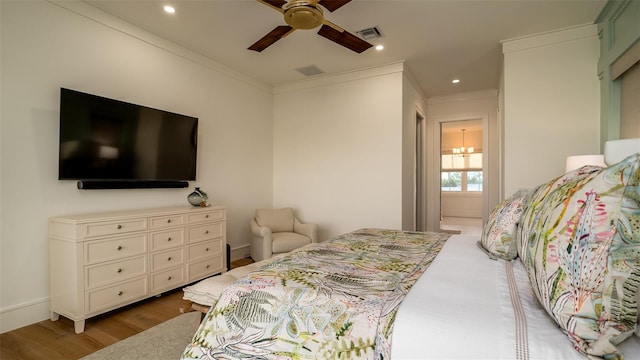 531 68th St, Holmes Beach, FL 34217 - bedroom with wood finished floors, crown molding, ceiling fan, and recessed lighting