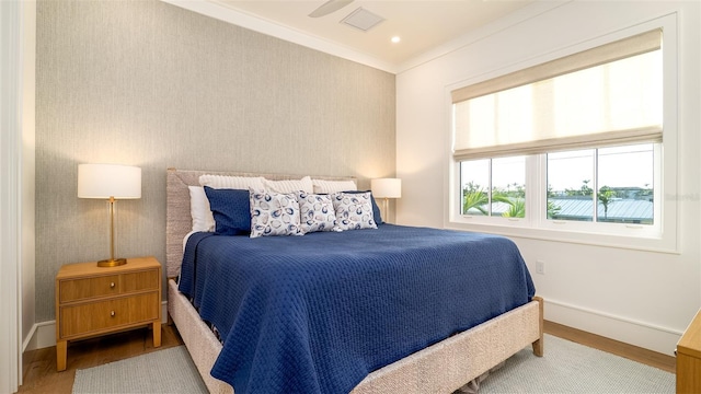 531 68th St, Holmes Beach, FL 34217 - bedroom featuring baseboards, wood finished floors, and ornamental molding