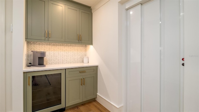 531 68th St, Holmes Beach, FL 34217 - bar featuring wine cooler, backsplash, light wood finished floors, and baseboards