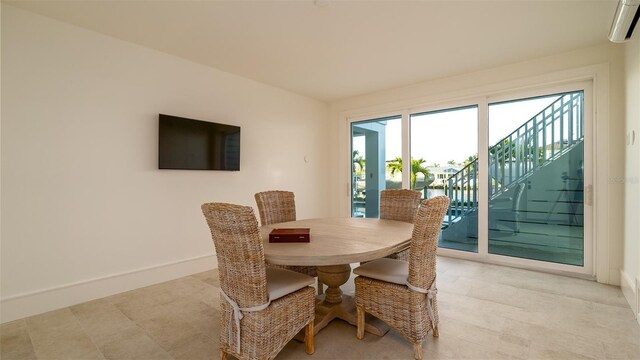 531 68th St, Holmes Beach, FL 34217 - dining space with baseboards, stairway, and a wall mounted air conditioner