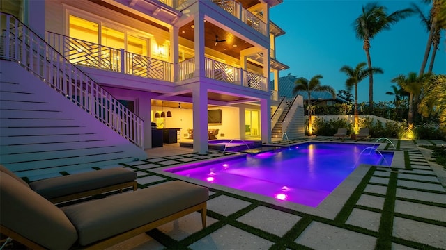 531 68th St, Holmes Beach, FL 34217 - pool at night with stairway, a patio, a pool with connected hot tub, and ceiling fan