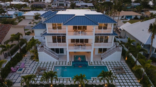 531 68th St, Holmes Beach, FL 34217 - view of building exterior with a fenced backyard, stairway, and an outdoor pool
