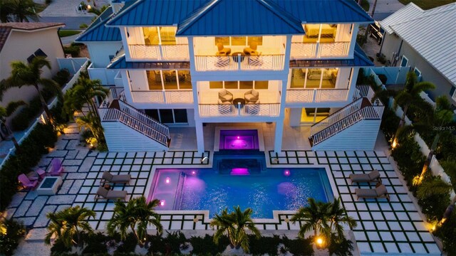 531 68th St, Holmes Beach, FL 34217 - rear view of property featuring stairway, a balcony, a standing seam roof, and board and batten siding