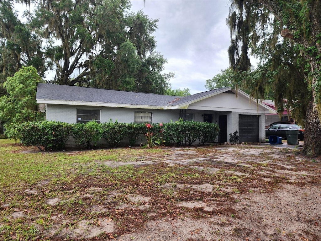 ranch-style house featuring brick siding and an attached garage