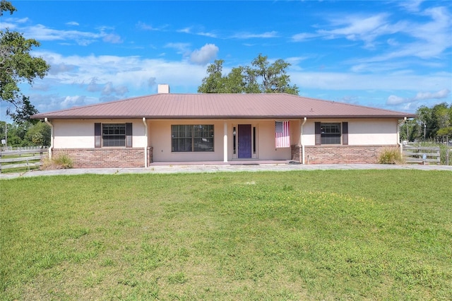 4404 Musket Dr, Lakeland, FL 33810 - ranch-style home with stucco siding, covered porch, brick siding, and metal roof