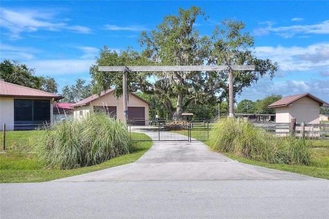 4404 Musket Dr, Lakeland, FL 33810 - view of concrete driveway with a gated entry and a gate