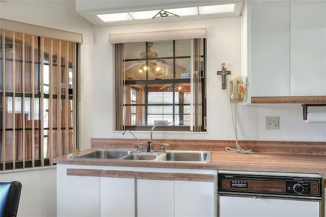 4404 Musket Dr, Lakeland, FL 33810 - kitchen featuring a sink, white cabinets, and light countertops