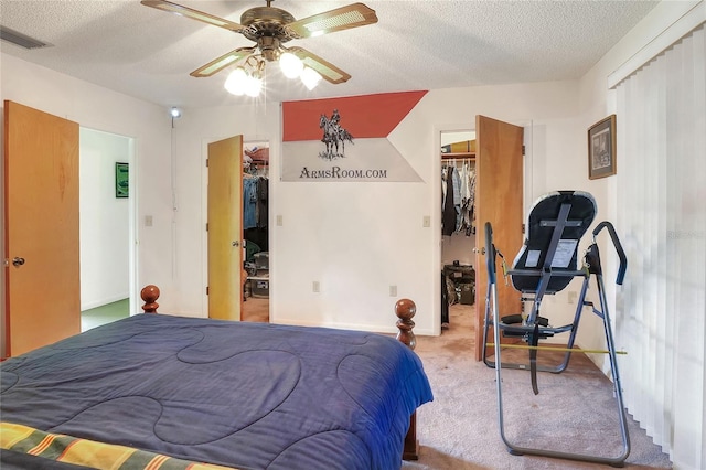 4404 Musket Dr, Lakeland, FL 33810 - carpeted bedroom with a walk in closet, a closet, a textured ceiling, a ceiling fan, and baseboards