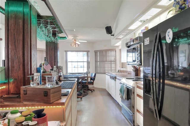 4404 Musket Dr, Lakeland, FL 33810 - kitchen with black refrigerator with ice dispenser, white range with electric cooktop, a textured ceiling, a ceiling fan, and paneled dishwasher